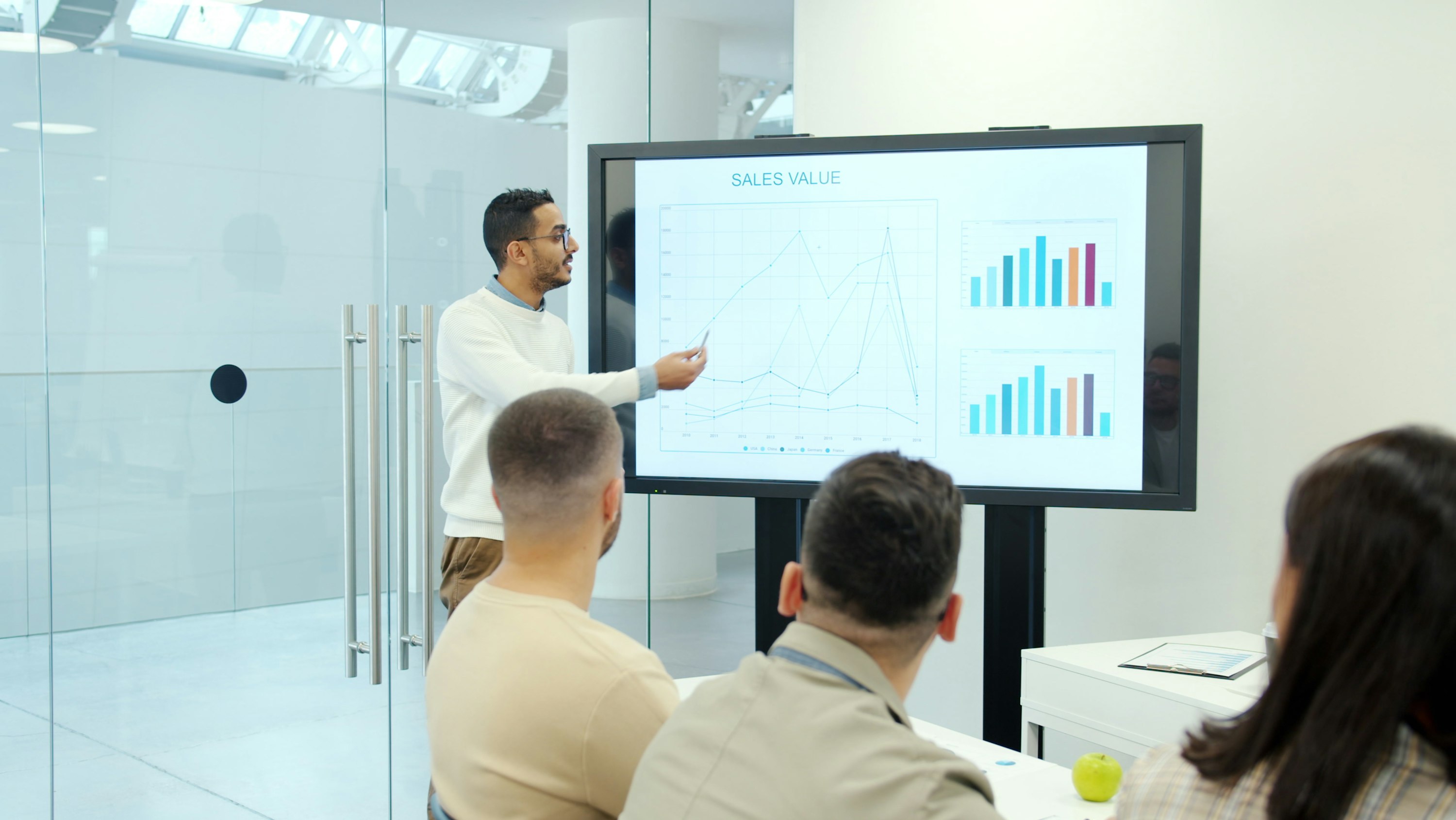 Trainer presenting sales and growth data to a workshop audience